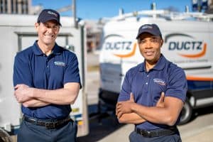 DUCTZ Technicians in front of service trucks