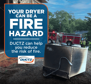 Dryer that has been severely burned and caused a fire sits outside of a building that fire fighters have just finished tending to
