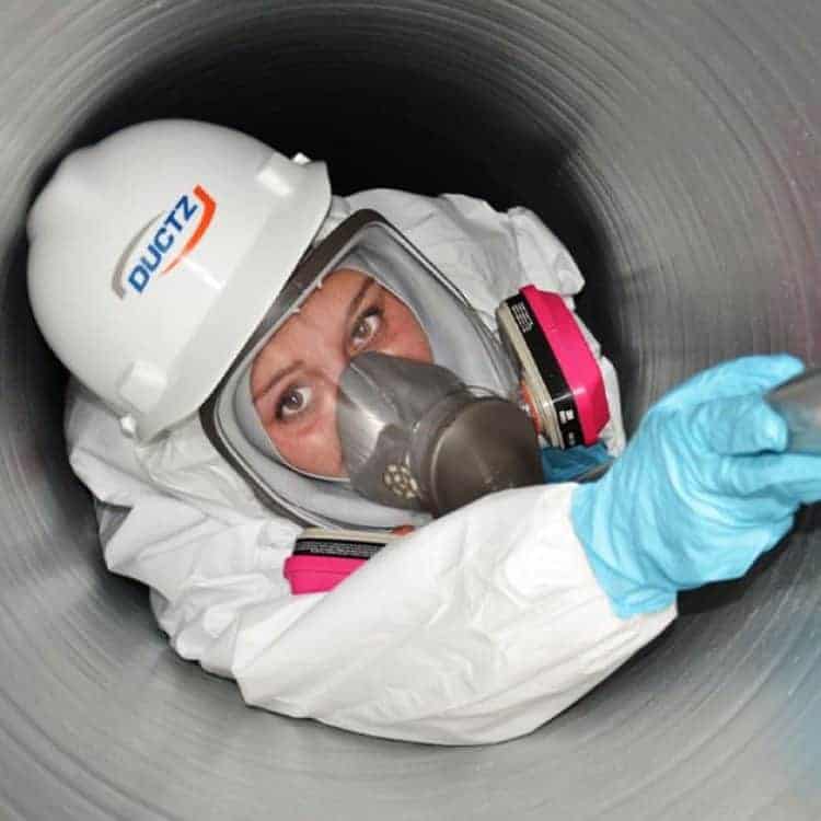 DUCTZ technician in an air duct cleaning