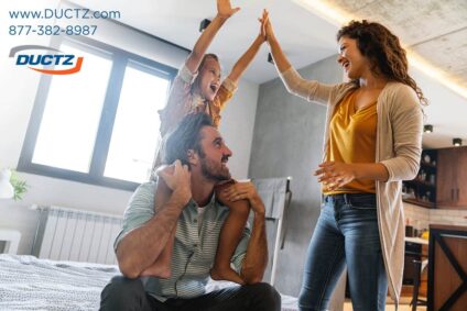 Dad holds child on his shoulders while mom gives a celebratory high five for improving energy efficiency